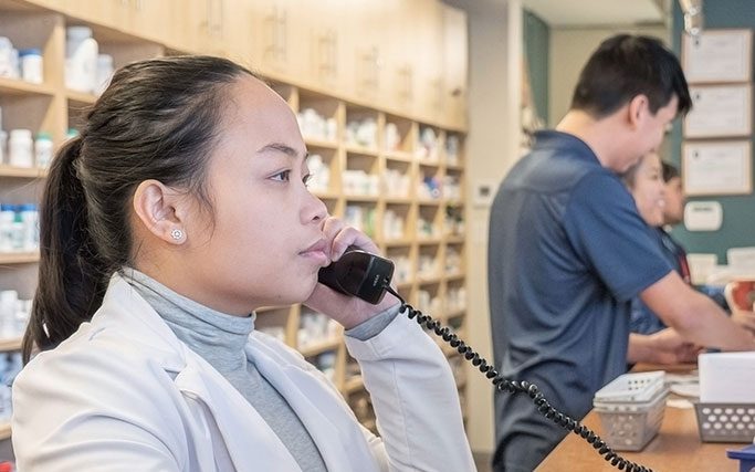 Pharmacist talking to a patient on the phone
