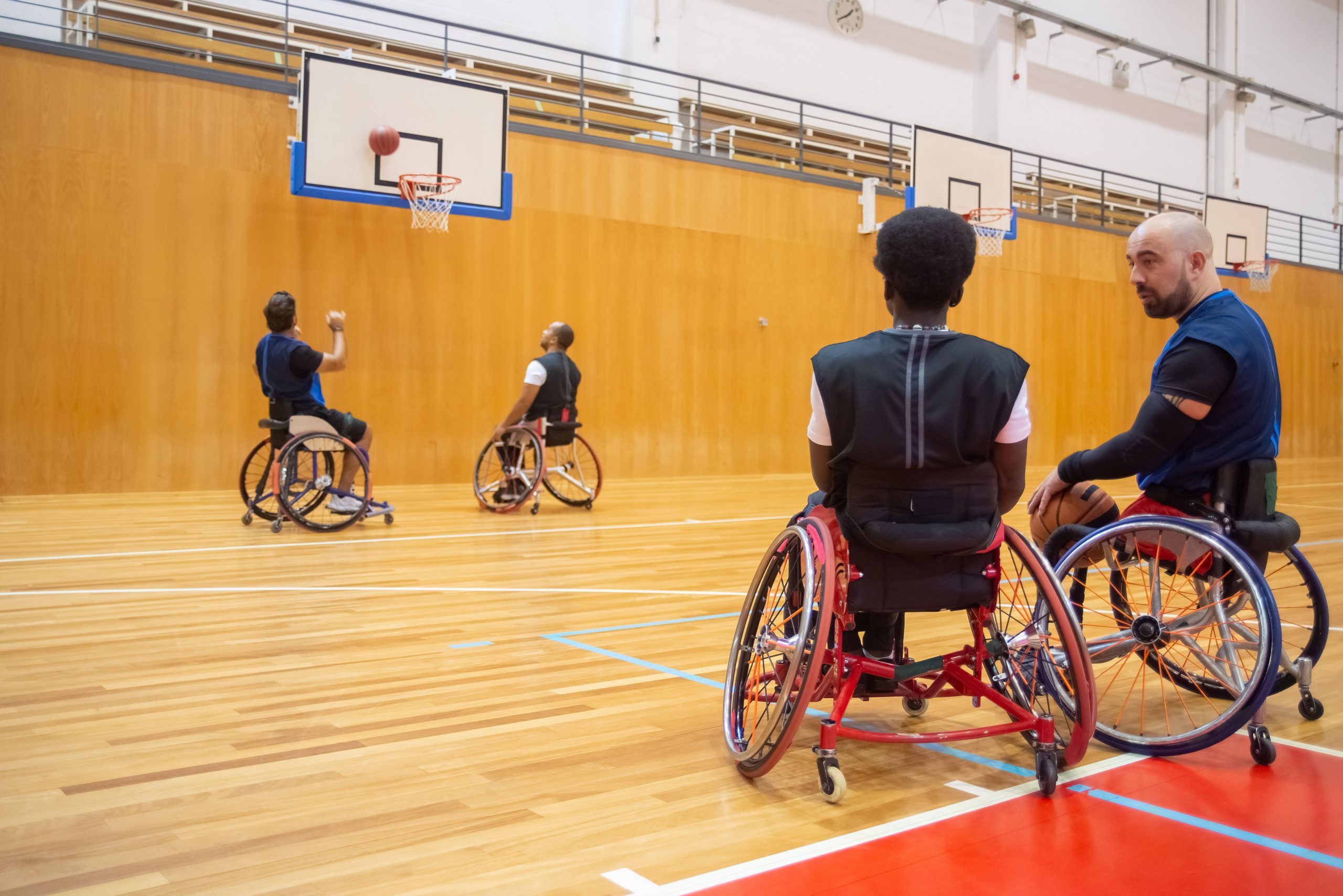 People in wheelchairs playing basketball